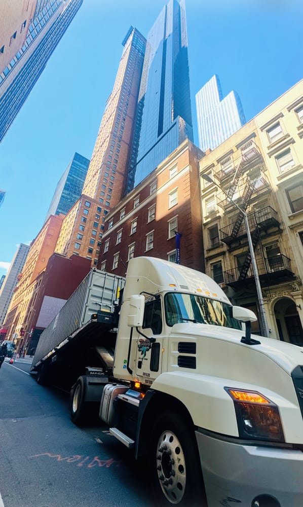 Bob's Express landoll trailer carrying a container on a midtown Manhattan street